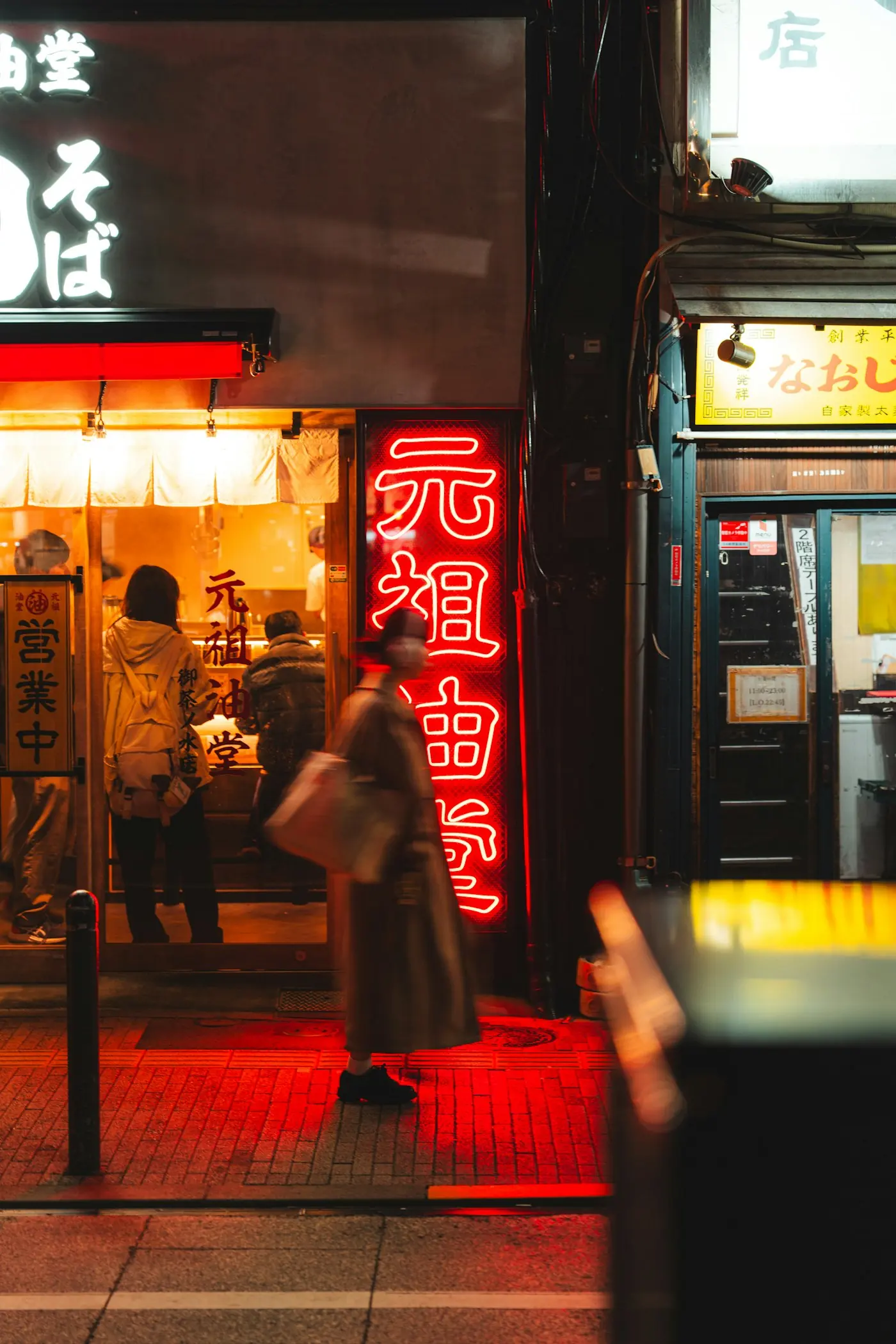 Tokyo street at night with neon signs competing for attention