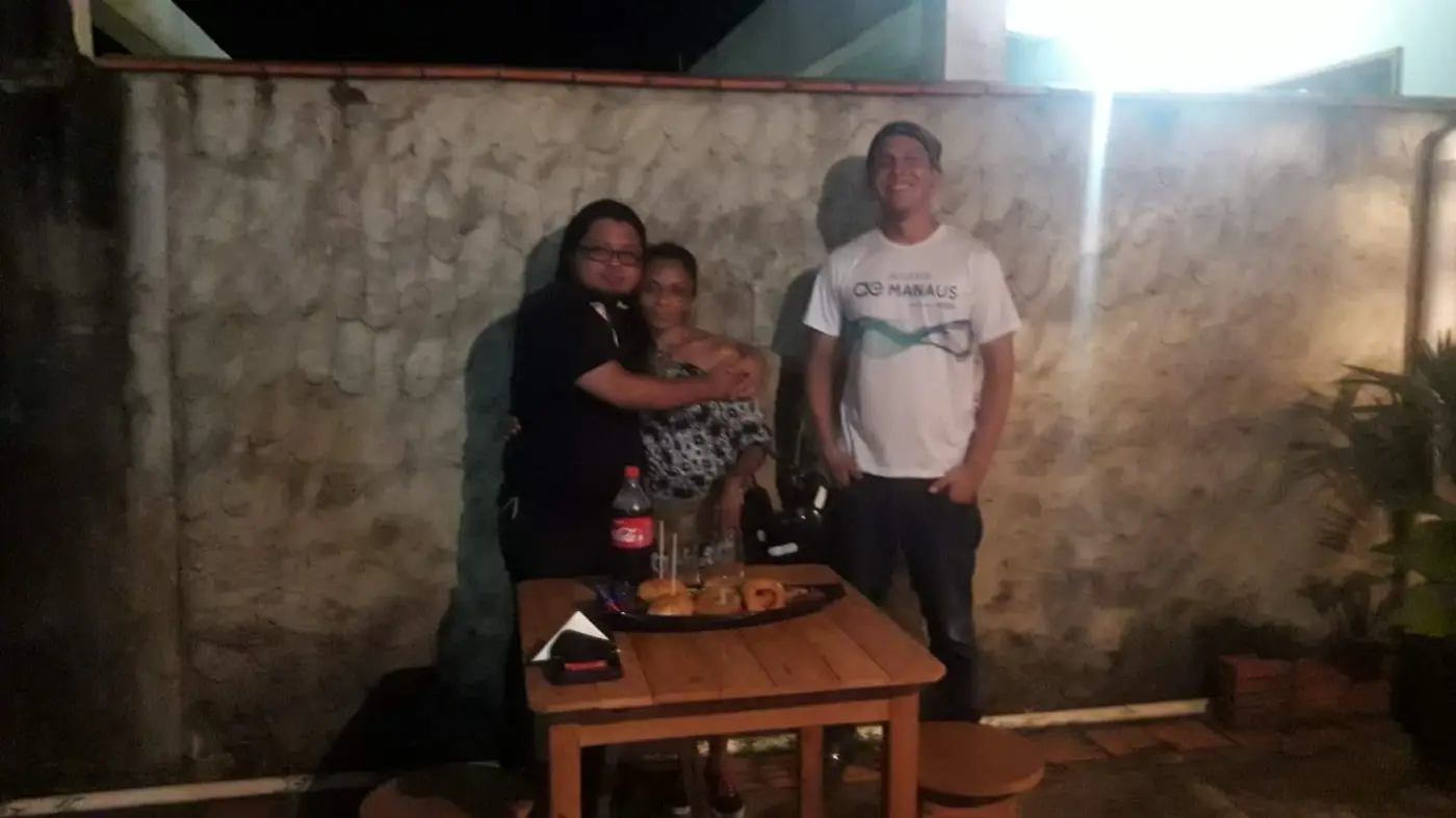 Gabriel serving customers at the burger shop in Parintins